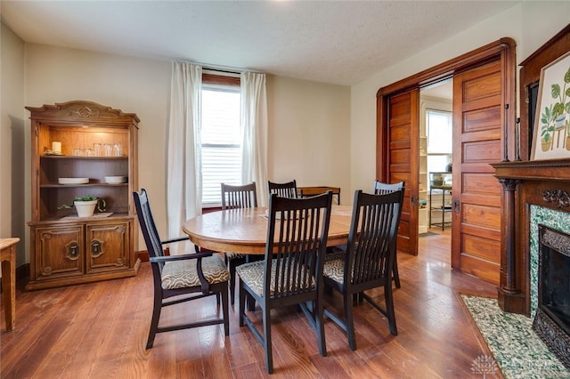 519 Prytania Ave, Hamilton, OH 45013 - dining area with a premium fireplace, wood finished floors, and a textured ceiling