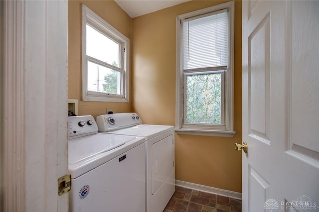 519 Prytania Ave, Hamilton, OH 45013 - washroom with washer and clothes dryer, baseboards, and dark stone finish flooring