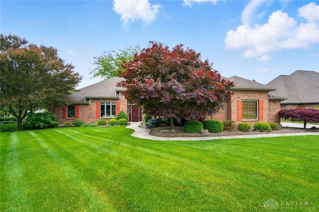 1403 Timshel St, Sugarcreek Township, OH 45440 - view of front of house featuring brick siding, a front lawn, and a shingled roof