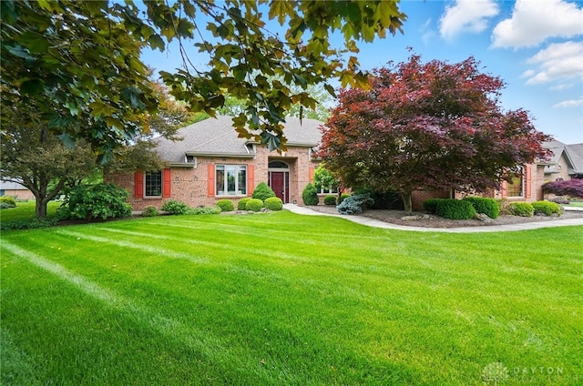 1403 Timshel St, Sugarcreek Township, OH 45440 - view of front of home with a front lawn, brick siding, and a shingled roof