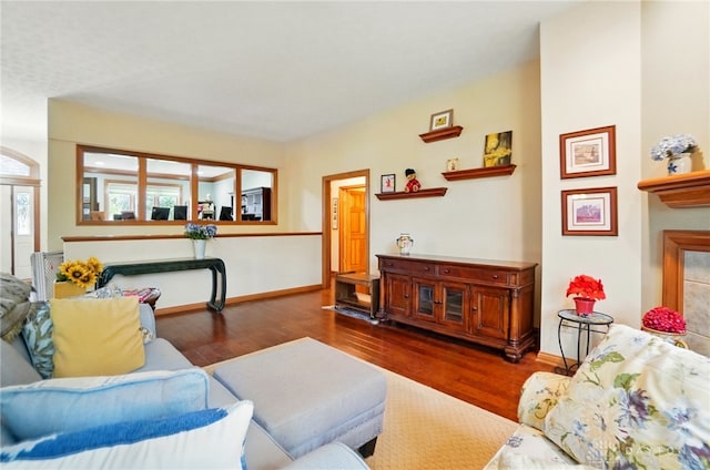 1403 Timshel St, Sugarcreek Township, OH 45440 - living area with wood finished floors, baseboards, and a tile fireplace