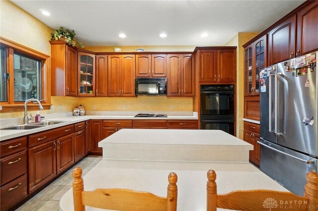 1403 Timshel St, Sugarcreek Township, OH 45440 - kitchen featuring black appliances, a sink, glass insert cabinets, light countertops, and recessed lighting