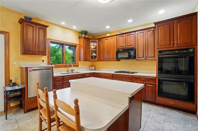 1403 Timshel St, Sugarcreek Township, OH 45440 - kitchen with black appliances, a sink, light countertops, recessed lighting, and glass insert cabinets
