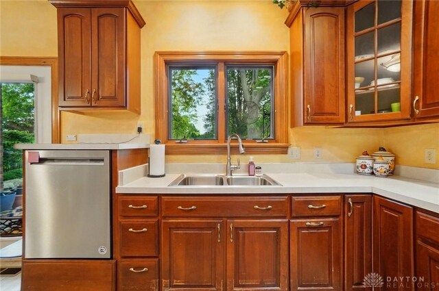 1403 Timshel St, Sugarcreek Township, OH 45440 - kitchen with stainless steel dishwasher, a sink, light countertops, and glass insert cabinets