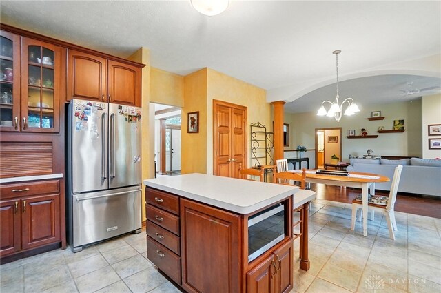 1403 Timshel St, Sugarcreek Township, OH 45440 - kitchen featuring appliances with stainless steel finishes, a chandelier, open floor plan, light tile patterned floors, and glass insert cabinets