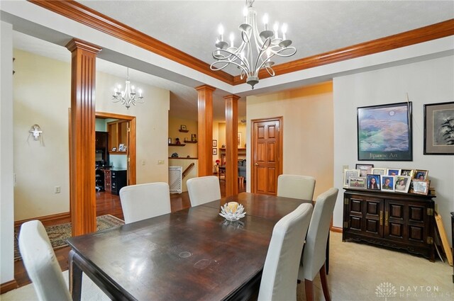 1403 Timshel St, Sugarcreek Township, OH 45440 - dining room featuring ornate columns, a chandelier, crown molding, a raised ceiling, and baseboards