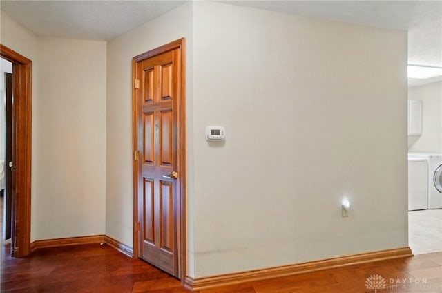 1403 Timshel St, Sugarcreek Township, OH 45440 - hall with wood finished floors, baseboards, and washer / dryer