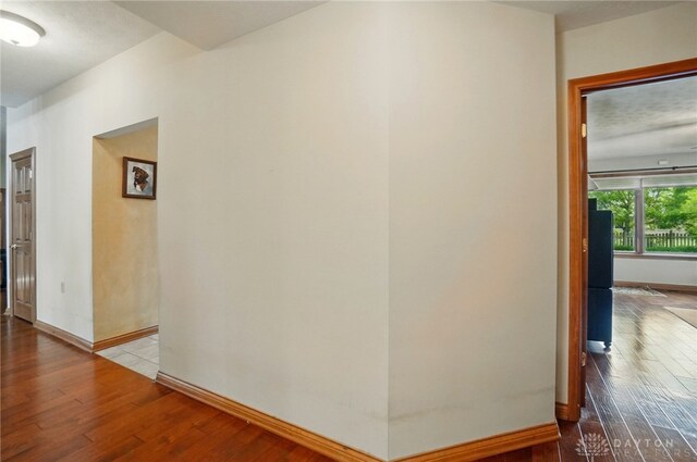1403 Timshel St, Sugarcreek Township, OH 45440 - hallway featuring hardwood / wood-style flooring and baseboards