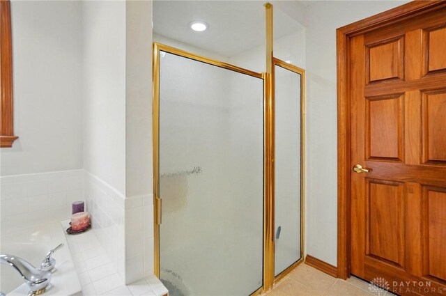 1403 Timshel St, Sugarcreek Township, OH 45440 - full bathroom featuring a shower stall, a garden tub, tile patterned floors, and recessed lighting