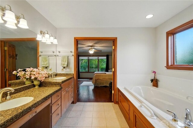 1403 Timshel St, Sugarcreek Township, OH 45440 - ensuite bathroom featuring tile patterned flooring, vanity, a garden tub, recessed lighting, and ceiling fan