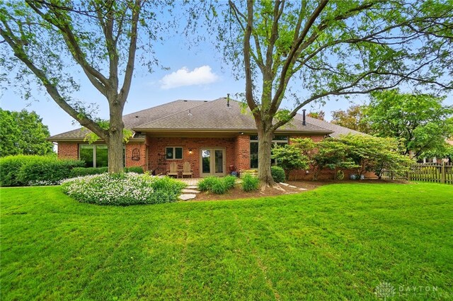 1403 Timshel St, Sugarcreek Township, OH 45440 - rear view of house featuring brick siding