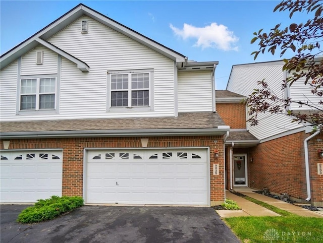 9235 Great Lakes Cir, Washington Twp, OH 45458 - traditional home featuring asphalt driveway, brick siding, an attached garage, and roof with shingles