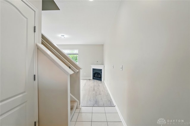 9235 Great Lakes Cir, Washington Twp, OH 45458 - hallway featuring stairs, light tile patterned floors, and baseboards
