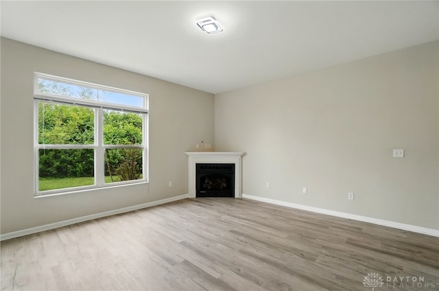 9235 Great Lakes Cir, Washington Twp, OH 45458 - unfurnished living room featuring wood finished floors, baseboards, and a fireplace