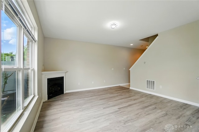 9235 Great Lakes Cir, Washington Twp, OH 45458 - unfurnished living room with light wood-type flooring, a fireplace, and baseboards