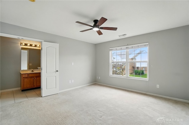 9235 Great Lakes Cir, Washington Twp, OH 45458 - unfurnished bedroom with light carpet, baseboards, a sink, ensuite bathroom, and ceiling fan