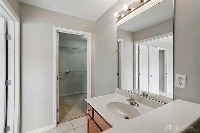 9235 Great Lakes Cir, Washington Twp, OH 45458 - bathroom featuring vanity, tile patterned flooring, a walk in closet, and baseboards
