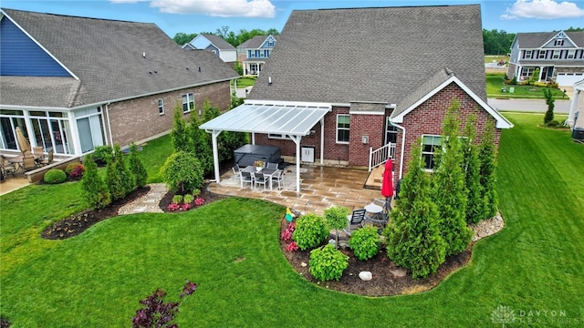 9777 Winding Creek Blvd, Clearcreek Twp, OH 45458 - rear view of house featuring brick siding, a patio, and a yard