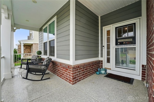 9777 Winding Creek Blvd, Clearcreek Twp, OH 45458 - view of exterior entry featuring a porch and brick siding