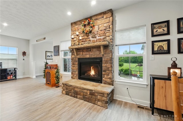 9777 Winding Creek Blvd, Clearcreek Twp, OH 45458 - living area with baseboards, wood finished floors, a fireplace, and recessed lighting