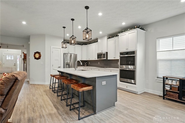 9777 Winding Creek Blvd, Clearcreek Twp, OH 45458 - kitchen with stainless steel appliances, a sink, baseboards, recessed lighting, and light wood-style floors