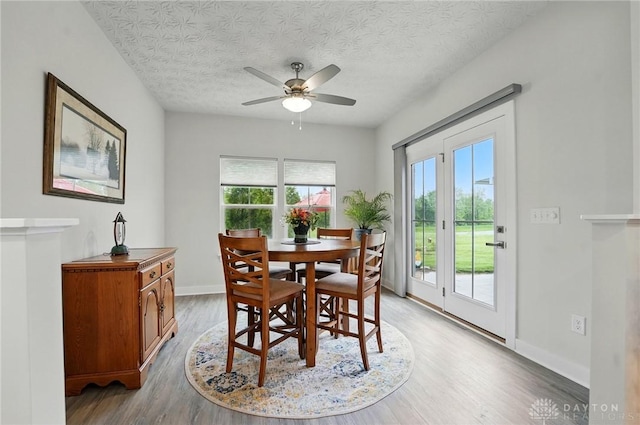 9777 Winding Creek Blvd, Clearcreek Twp, OH 45458 - dining space with ceiling fan, light wood-style flooring, baseboards, and a textured ceiling