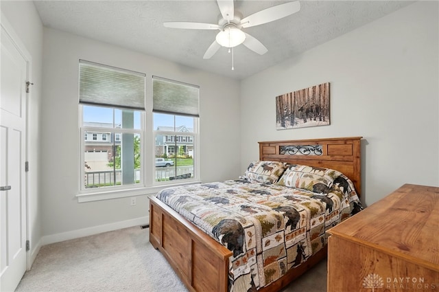 9777 Winding Creek Blvd, Clearcreek Twp, OH 45458 - bedroom featuring baseboards, light colored carpet, ceiling fan, and a textured ceiling