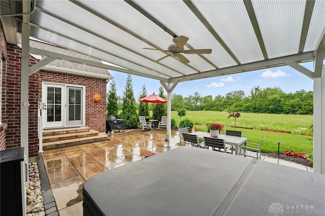9777 Winding Creek Blvd, Clearcreek Twp, OH 45458 - view of patio / terrace featuring outdoor dining area, a ceiling fan, entry steps, and view of wooded area