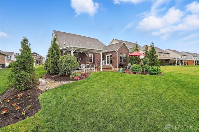 9777 Winding Creek Blvd, Clearcreek Twp, OH 45458 - back of property with a lawn, brick siding, and a patio area