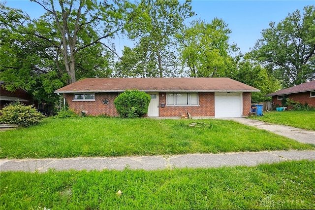 5059 Key W Dr, Dayton, OH 45424 - ranch-style house with an attached garage, driveway, brick siding, and a front lawn