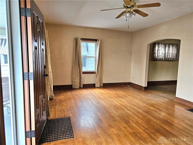1800 Patterson Rd, Dayton, OH 45420 - spare room featuring hardwood / wood-style floors, arched walkways, a ceiling fan, and baseboards