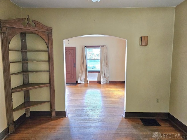 1800 Patterson Rd, Dayton, OH 45420 - corridor featuring wood finished floors, arched walkways, and baseboards