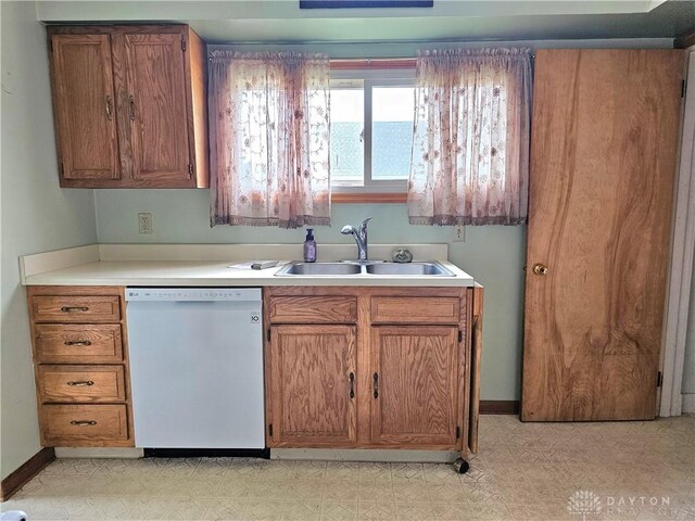 1800 Patterson Rd, Dayton, OH 45420 - kitchen with dishwasher, a sink, light countertops, and brown cabinets