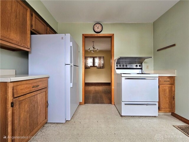1800 Patterson Rd, Dayton, OH 45420 - kitchen featuring white appliances, light countertops, baseboards, and a chandelier