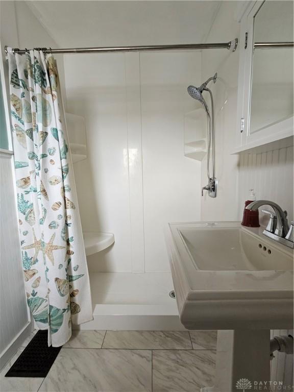 1800 Patterson Rd, Dayton, OH 45420 - full bath featuring a shower with curtain and marble finish floors