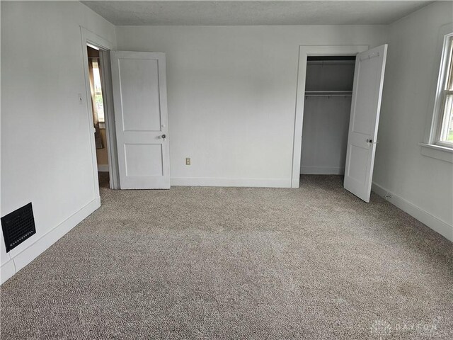 1800 Patterson Rd, Dayton, OH 45420 - unfurnished bedroom with carpet floors, baseboards, and a closet