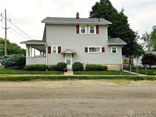 1800 Patterson Rd, Dayton, OH 45420 - view of front of house featuring a chimney and a shingled roof