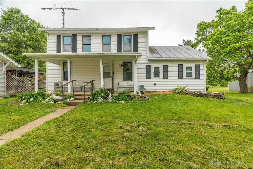 304 Main St, Gordon, OH 45304 - view of front of home featuring covered porch, a front yard, a standing seam roof, and a metal roof