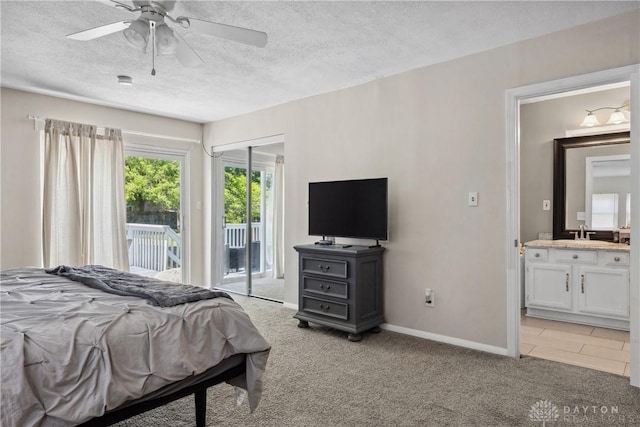 2089 Clearview Dr, Bellbrook, OH 45305 - bedroom with access to outside, a textured ceiling, a sink, ensuite bathroom, and light colored carpet