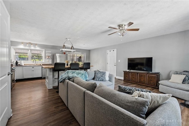 2089 Clearview Dr, Bellbrook, OH 45305 - living room with a textured ceiling, a ceiling fan, dark wood finished floors, and baseboards