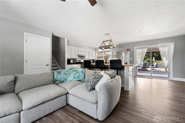 2089 Clearview Dr, Bellbrook, OH 45305 - living room featuring stairs, baseboards, dark wood finished floors, and a ceiling fan