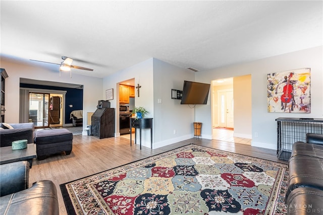 4491 Powder Horn Dr, Beavercreek, OH 45432 - living room featuring light wood-style floors, a ceiling fan, and baseboards