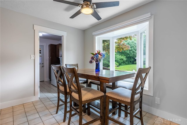 4491 Powder Horn Dr, Beavercreek, OH 45432 - dining area featuring baseboards, light tile patterned floors, and a ceiling fan