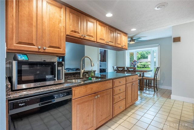 4491 Powder Horn Dr, Beavercreek, OH 45432 - kitchen featuring a sink, black dishwasher, stainless steel microwave, light tile patterned floors, and ceiling fan