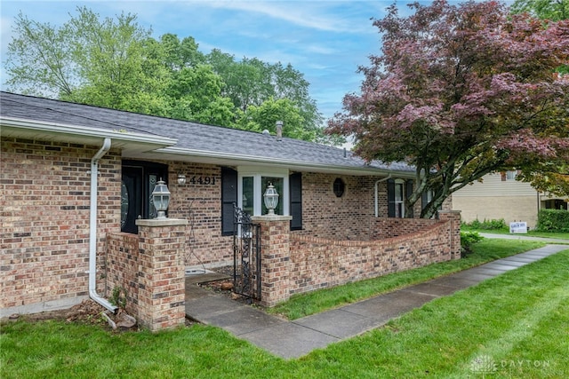 4491 Powder Horn Dr, Beavercreek, OH 45432 - view of front of house with brick siding, a front lawn, and roof with shingles