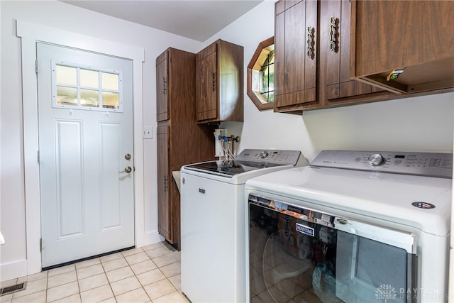 4491 Powder Horn Dr, Beavercreek, OH 45432 - laundry room with cabinet space, independent washer and dryer, and light tile patterned floors