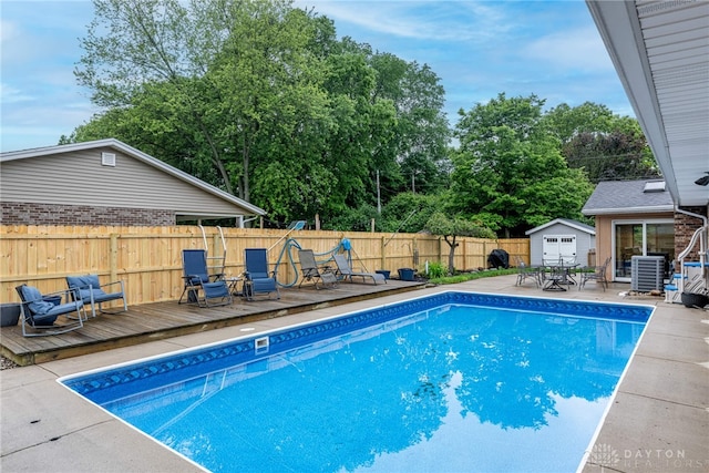 4491 Powder Horn Dr, Beavercreek, OH 45432 - view of pool featuring a wooden deck, a fenced backyard, central AC unit, and view of scattered trees