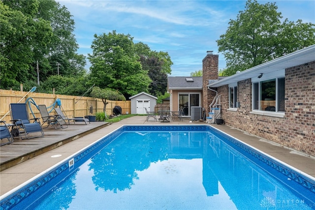 4491 Powder Horn Dr, Beavercreek, OH 45432 - view of swimming pool with a fenced backyard, central air condition unit, a wooden deck, and a patio area