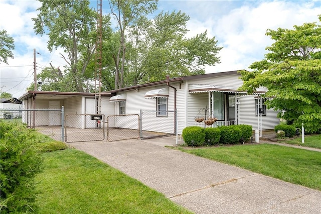 903 Kennison Ave, New Carlisle, OH 45344 - view of front of property with a gate, driveway, and a carport