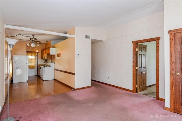 903 Kennison Ave, New Carlisle, OH 45344 - unfurnished living room featuring carpet floors, ceiling fan, and baseboards